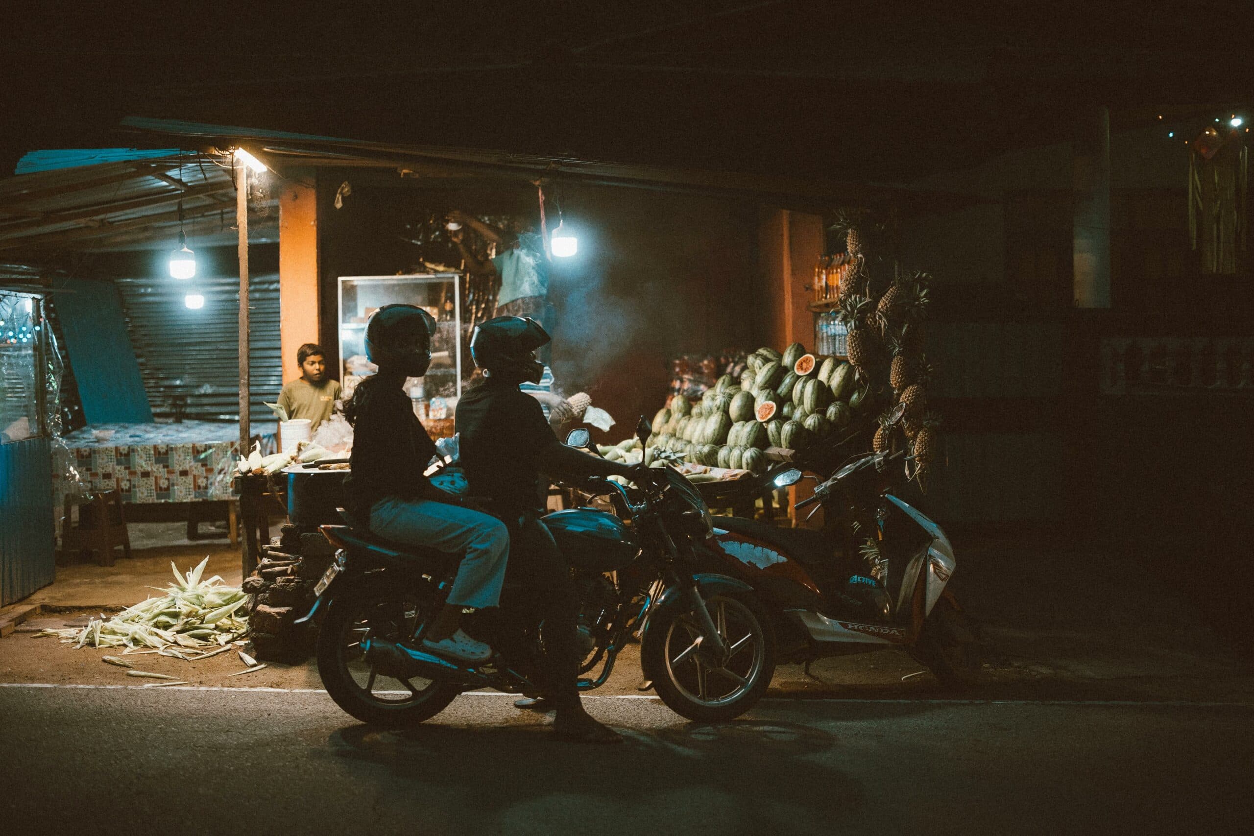 Night street market with fruit vendors